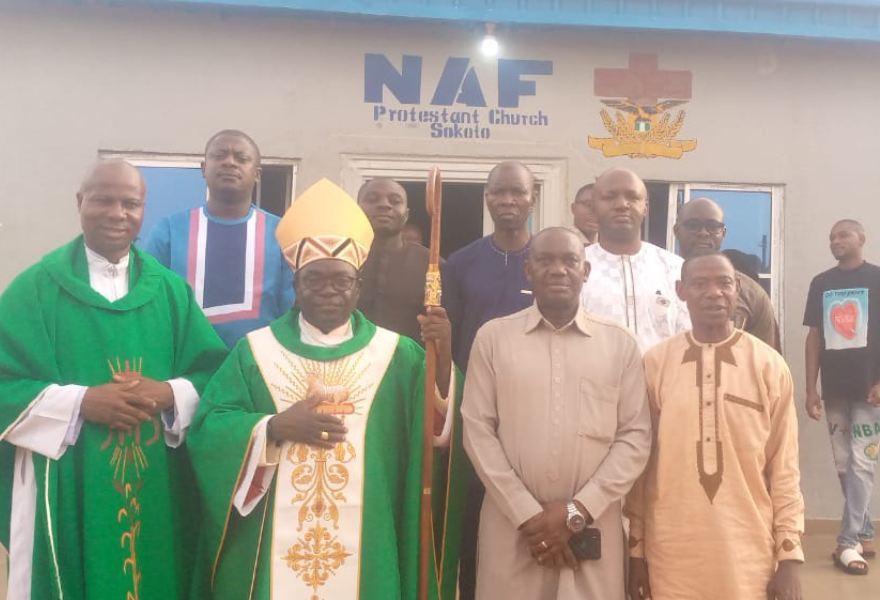 * Bishop Matthew Hassan Kukah, Bishop of Sokoto Catholic Diocese (middle) and Air Commodore David Aluko, the outgoing Commanding Officer, 119 Air Force Composite Base, Mana, Sokoto, shortly after celebrating the Holy Mass last Sunday. Photo by: Ankeli Emmanuel, Sokoto.