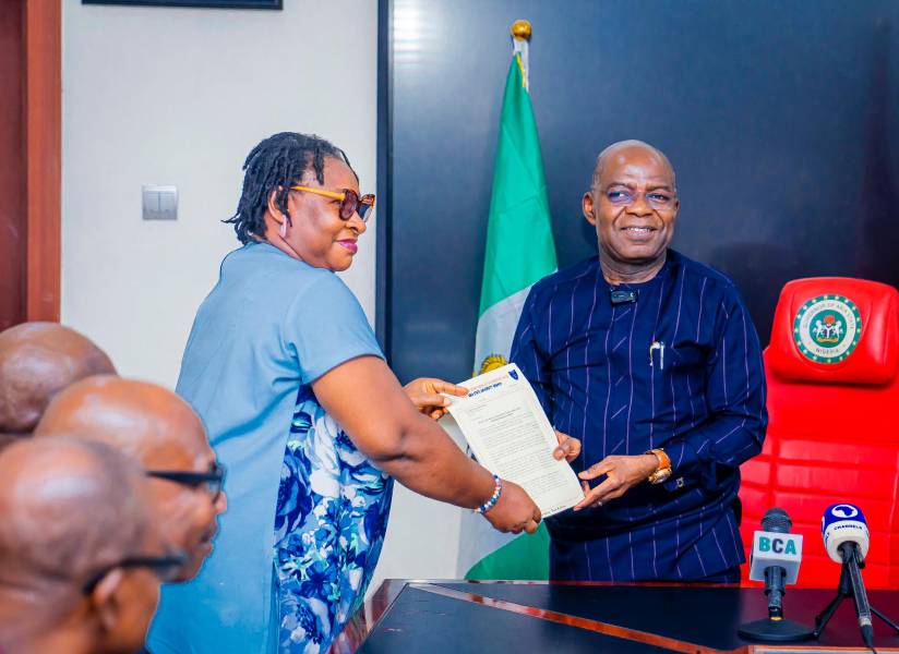 Dr. Happiness Uduak presents ASUU ABSU letter to Governor Otti during the union's visit.