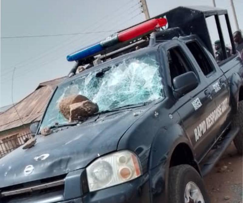 The damaged police patrol van during the protest.
