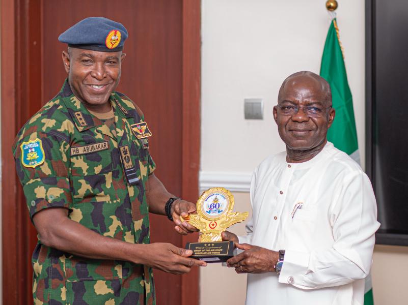 Governor Otti receives a souvenir from the visiting Chief of Air Staff, Air Marshal Hasan Abubakar.