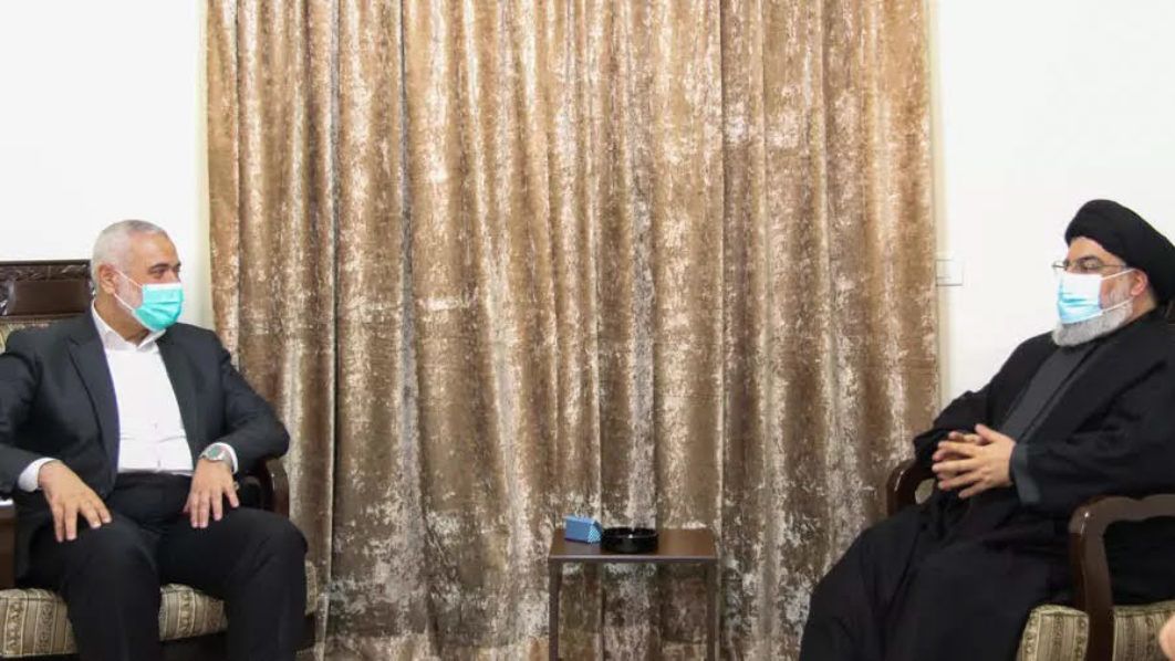 The head of Lebanon’s militant Shiite Muslim movement Hezbollah, Hassan Nasrallah (R), is shown meeting Hamas’ political bureau chief Ismail Haniya at an undisclosed location, in a picture from the Hezbollah press office – Hezbollah press office/AFP