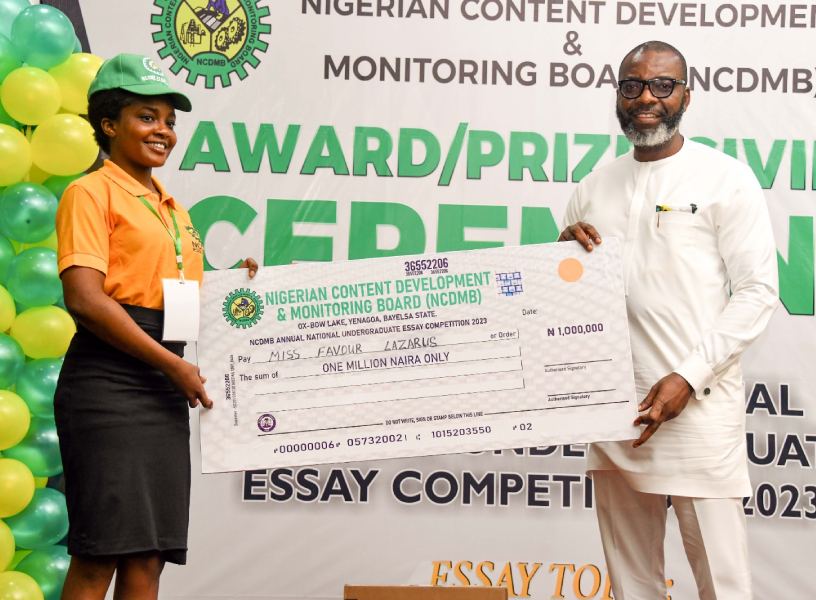 *  First prize winner of the 7th Nigerian Content Annual National Undergraduate Essay Competition, 2023, Miss Iruoma Favour Lazarus, with the Manager Corporate Communications, Nigerian Content Development and Monitoring Board (NCDMB), Mr. Esueme Dan Kikile, Esq at the grand finale held on Wednesday at the Lady Daima Memorial Event Center, Yenagoa, Bayelsa State.