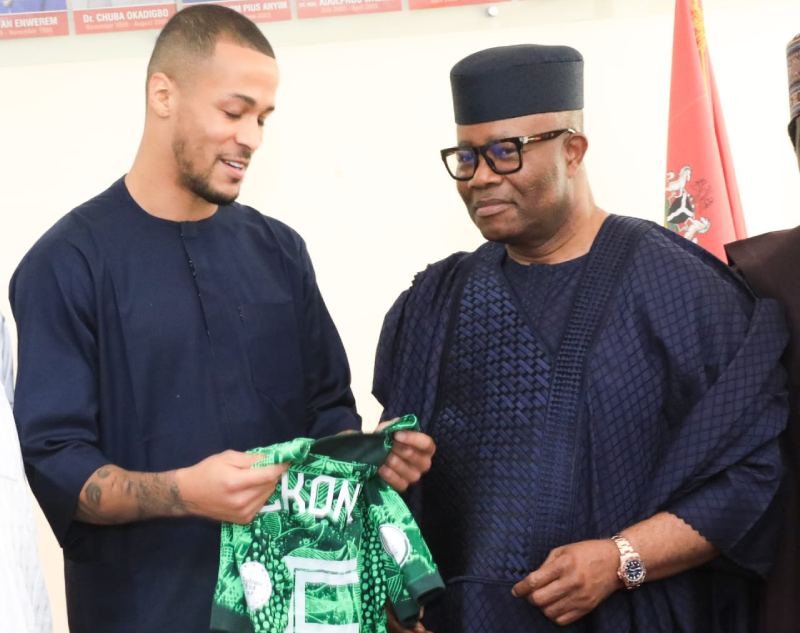 Senator Godswill Akpabio (right) with the Super Eagles of Nigeria Captain, William Troost-Ekong, when he received the players.