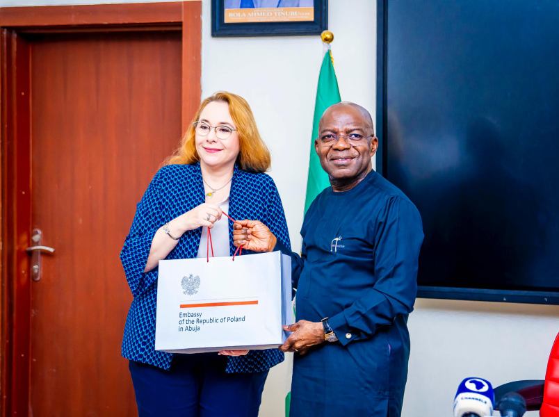 The Polish Ambassador presents a gift pack to Dr. Otti.