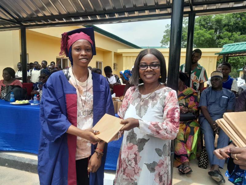Mrs Juliet Nwabiani Okafor, Vice Chairman, PTA Model Junior Secondary School, Maitama, Abuja (right) presenting an award prize to one of the outstanding graduating student of JS 3 during the Send Forth/Prize Giving event.