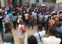 *  A throng of bank customers waiting to get cash