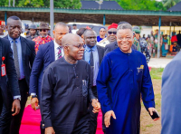 Governor Otti, walking into the venue of the funeral service, accompanied by Retired Major General Umahi (right).