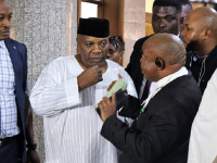  *  Okupe Conferring With His Lawyers During Court Trial