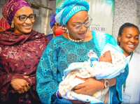 Senator Oluremi Tinubu, wife of Nigeria's President, cuddling the 2024 New Year Baby during her visit to the National Hospital Abuja on Monday.