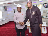 Senator (Engr) Dave Nweze Umahi, Nigeria's Minister of Works (left) and Mr Shuaib Audu, Minister of Steel Development (right) in a handshake.