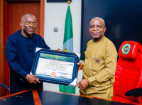 Prof Okenwa (left) presenting the certificate of Provisional License to Operate as a Private University  of Lux Mundi University, Umuahia, to Governor Otti.